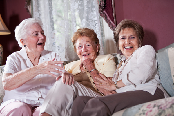 three elderly women laughing